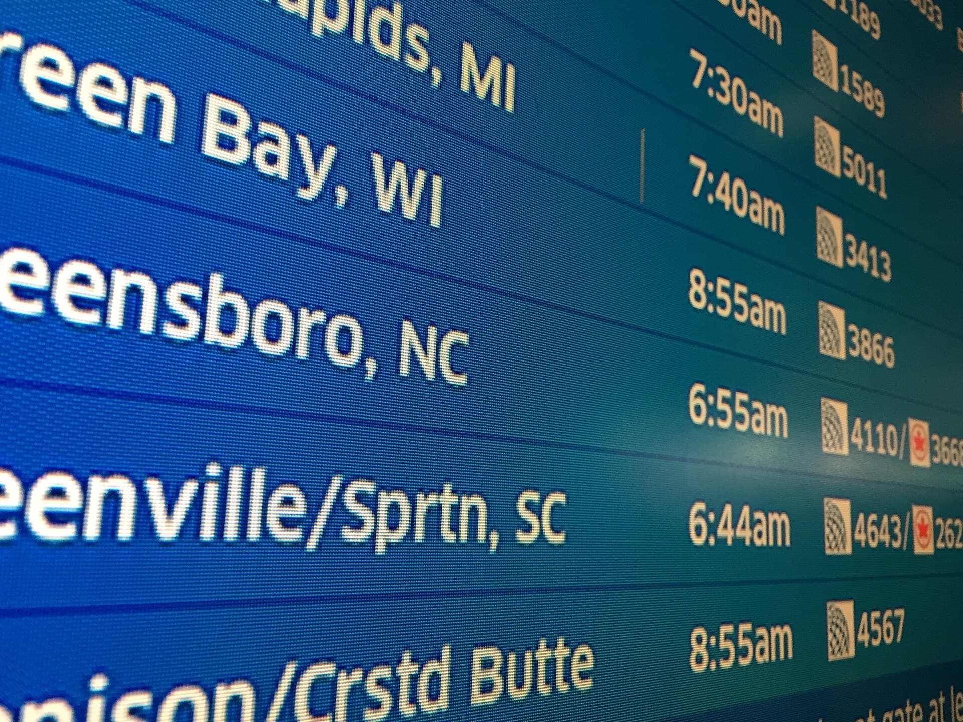 Airport departure board listing flights