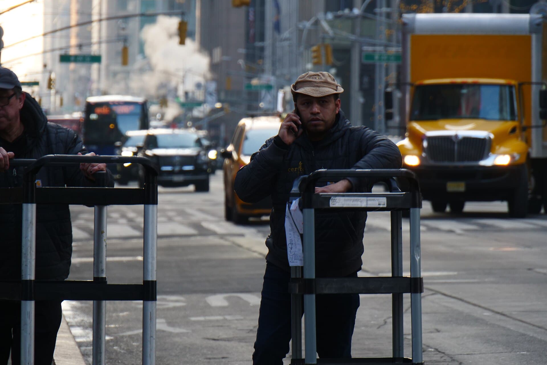 A man taking a call on a busy Manhattan street